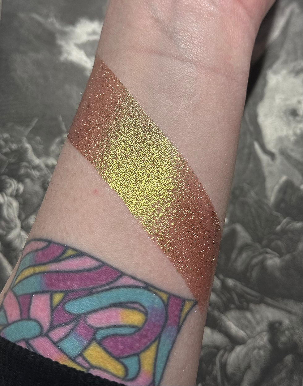 Thumbnail: Arm with Goldenrod - Duo Chrome Golden Shimmer Eyeshadow, various colors, tattoo visible.
