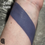 Thumbnail: Arm swatch with Eerie Silence text, Dark Matter - Sheer Berry Blue Shimmer Lip Gloss i.