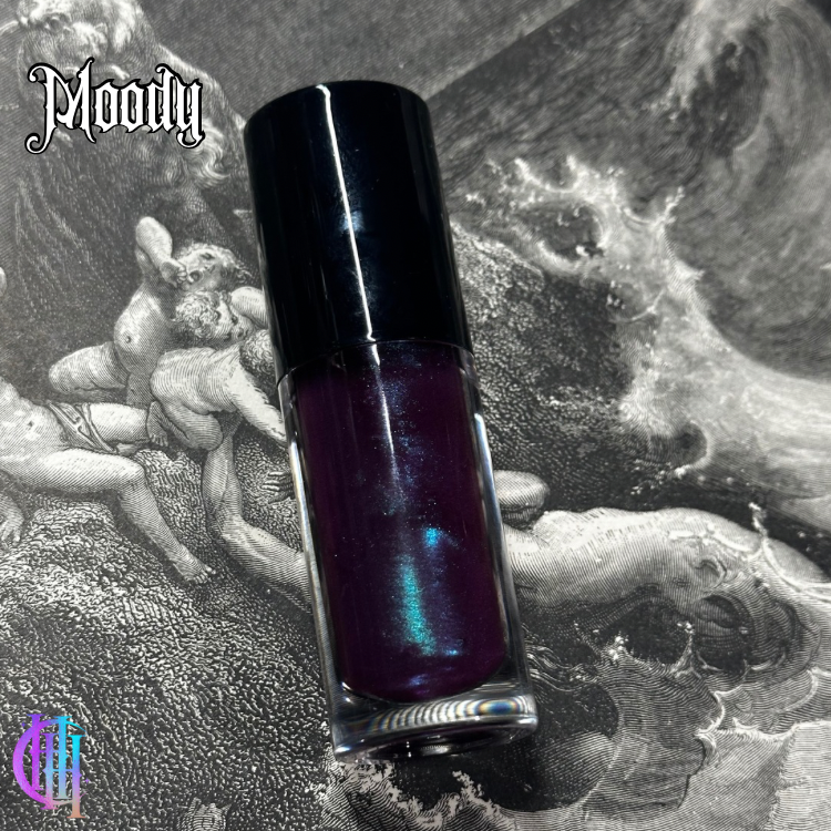Thumbnail: A dark purple lip gloss bottle, text reads "Bloody" and The Shivers - Vegan Lip Cream Balm.