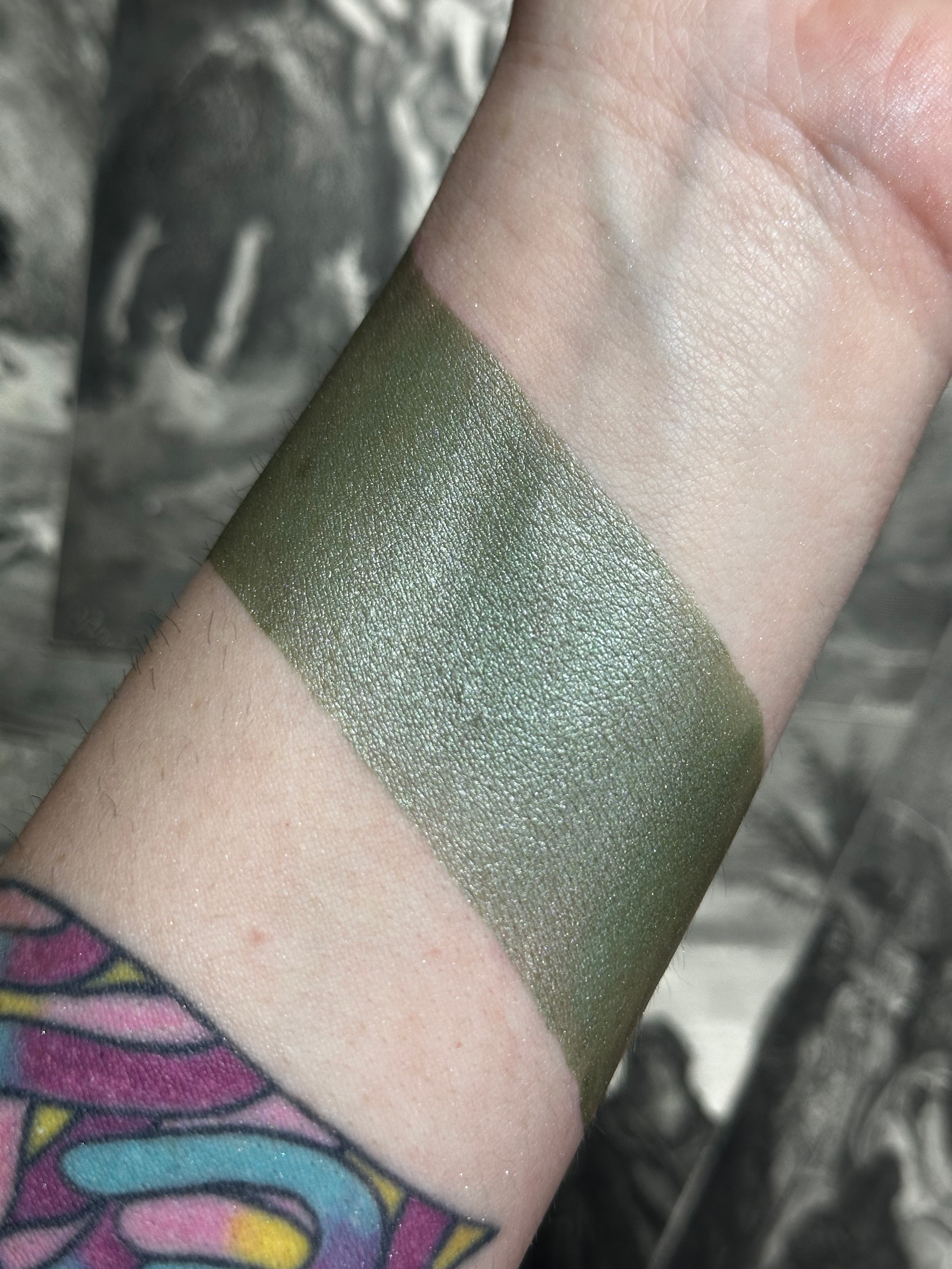 Green shimmer swatch on wrist, Devilish Whispers - Green Shimmer Tone Velvet Creams.