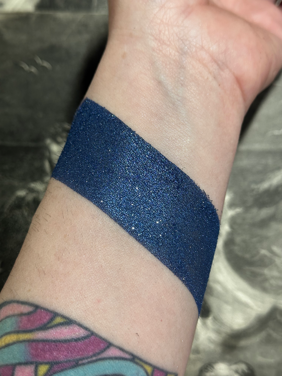 Thumbnail: Navy blue shimmer swatch on a wrist, Dark Matter - Sheer Berry Blue Shimmer Lip Gloss i.