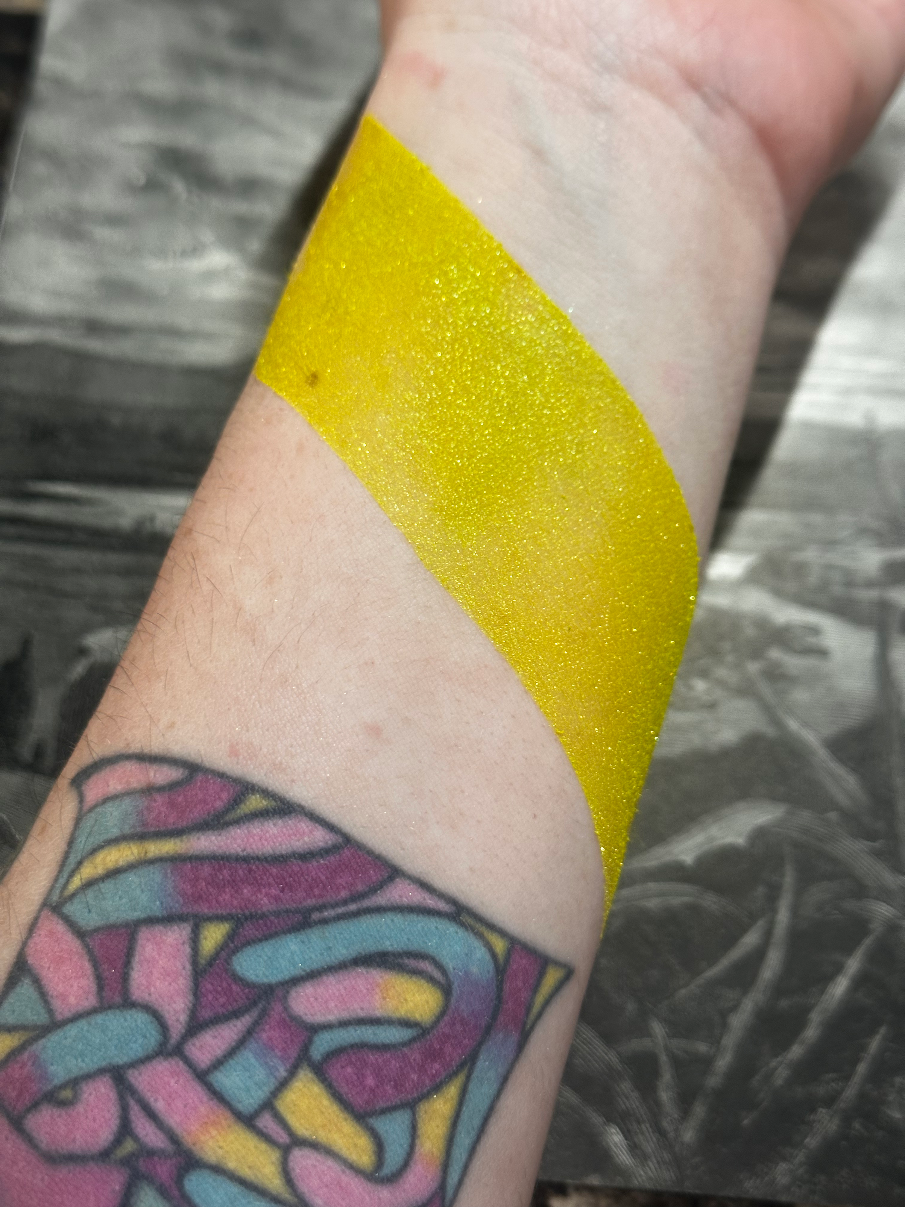 Yellow highlighter swatch on wrist with tattoo, Under the Moon - Gloomy Glow Highlighters - Vegan