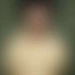 A Black woman with light brown skin and a loosely pulled back afro opens her mouth wide, as though she is screaming