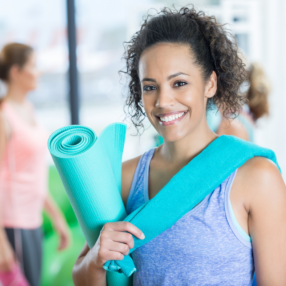 Personal trainer holding a yoga mat