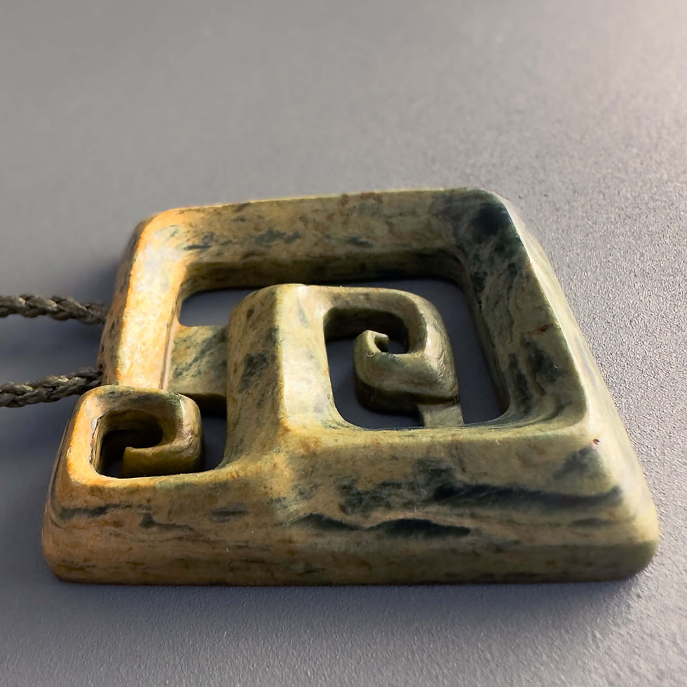 Thumbnail: Closeup view of handcrafted Koru pendant from Aotearoa Stone Carving Studio
