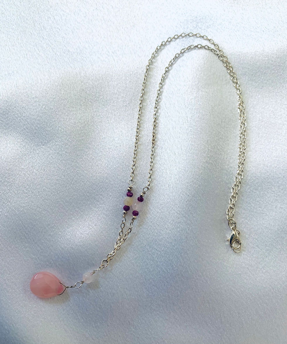 This handmade gemstone necklace includes a Rose Quartz briolette, Moonstone & Tourmaline  beads on a sterling silver chain.