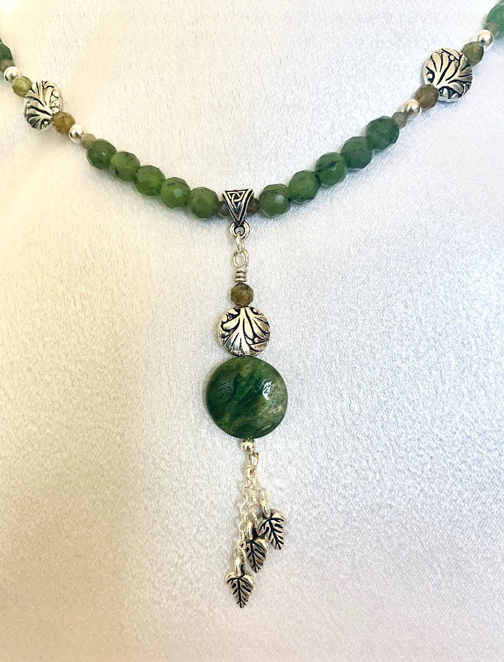 Thumbnail: This handmade gemstone necklace includes a circular Nephrite Jade, silver plated decor & leaves on a strand of Jade beads.