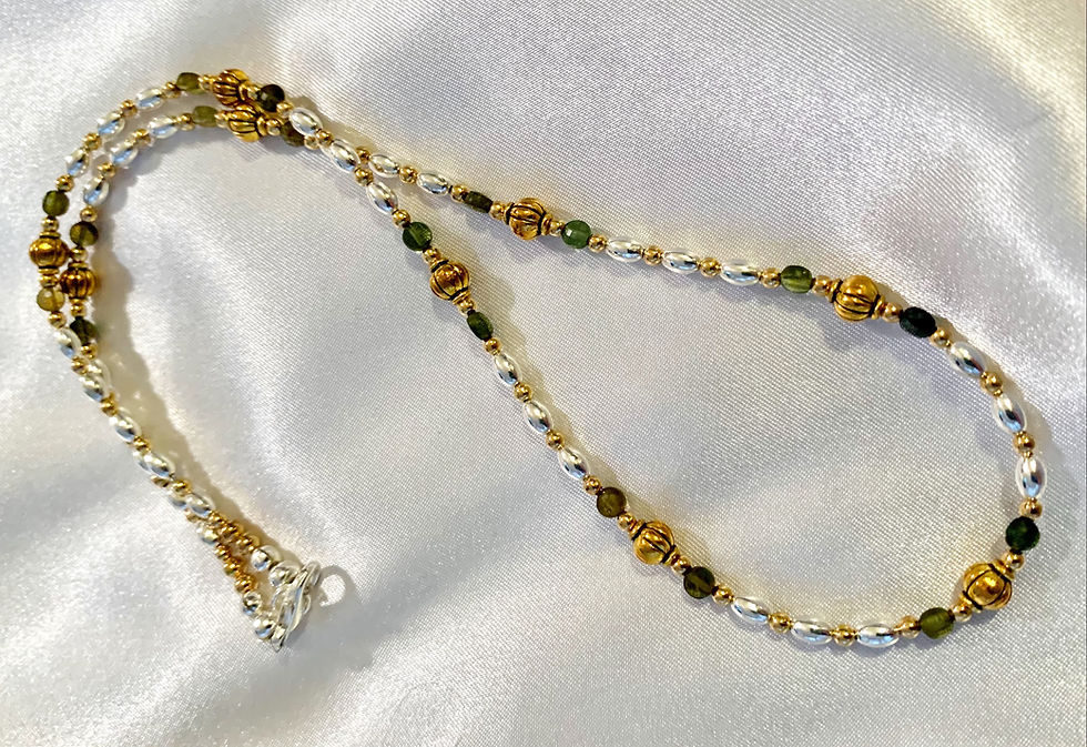 Thumbnail: This handmade gemstone necklace includes Green Garnet and silver plated beads.