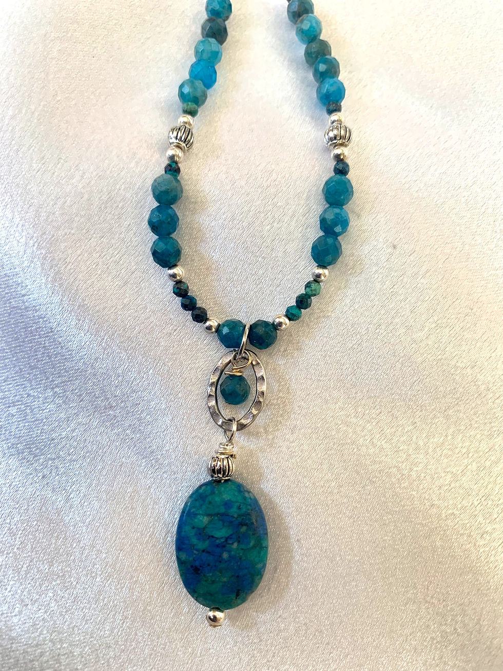 Thumbnail: This handmade gemstone necklace includes a Blue Chrysocolla dangling on a strand of Apatite, Moonstone  & silver plated beads