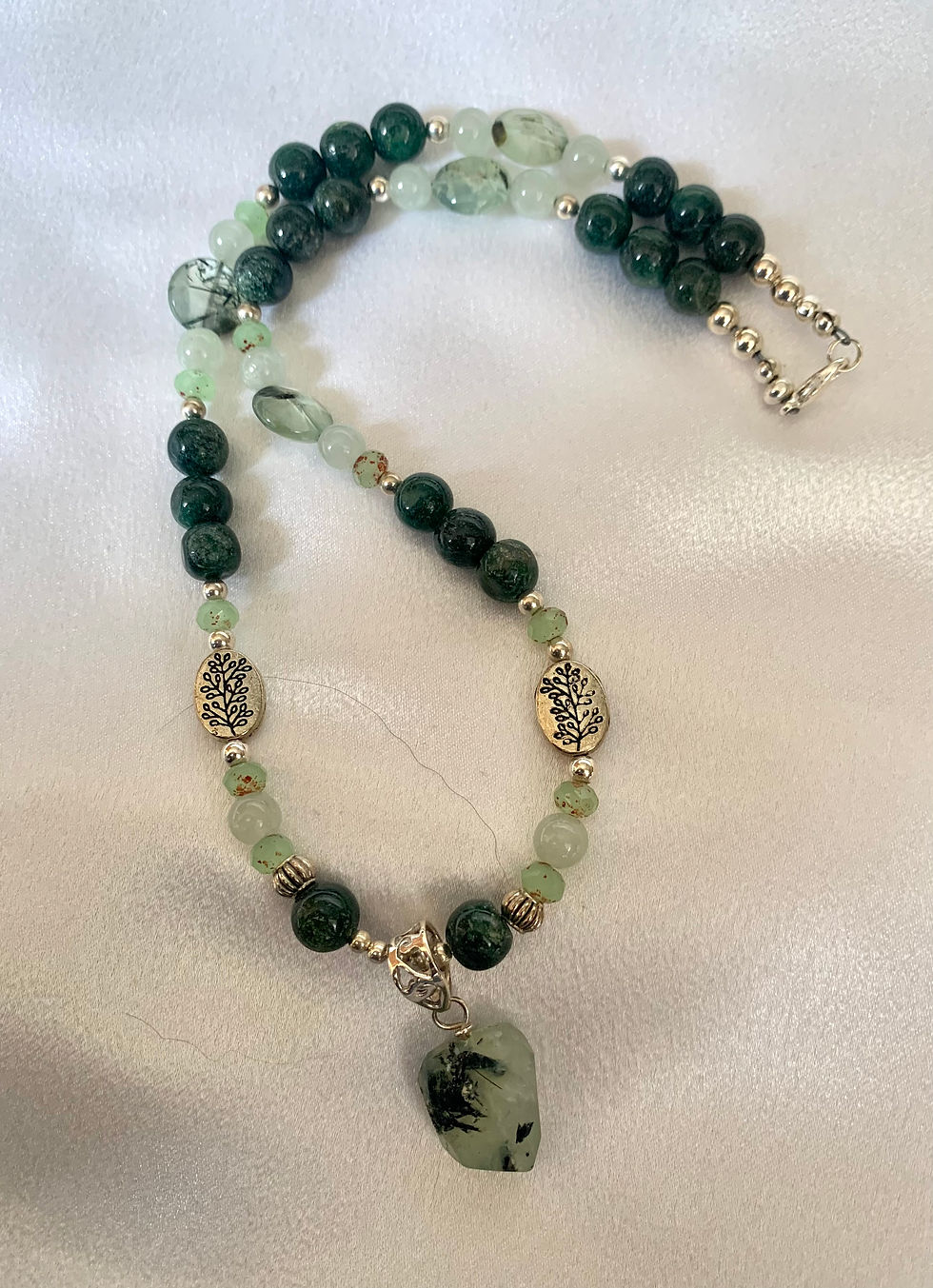 Thumbnail: This handmade gemstone necklace includes a cut Green Prehnite dangling on a strand of Prehnite, Jasper & silver plated beads.