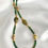 Thumbnail: This handmade gemstone necklace includes a strand faceted Green Garnet & Diopside & gold plated beads.