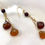Thumbnail: These handmade gemstone earrings include Honey & Amber Chalcedony stones dangles from gold chain links & a tigers eye bead.