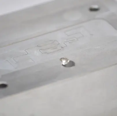 Laser machined microfluidic mold surface with high precision microstructures