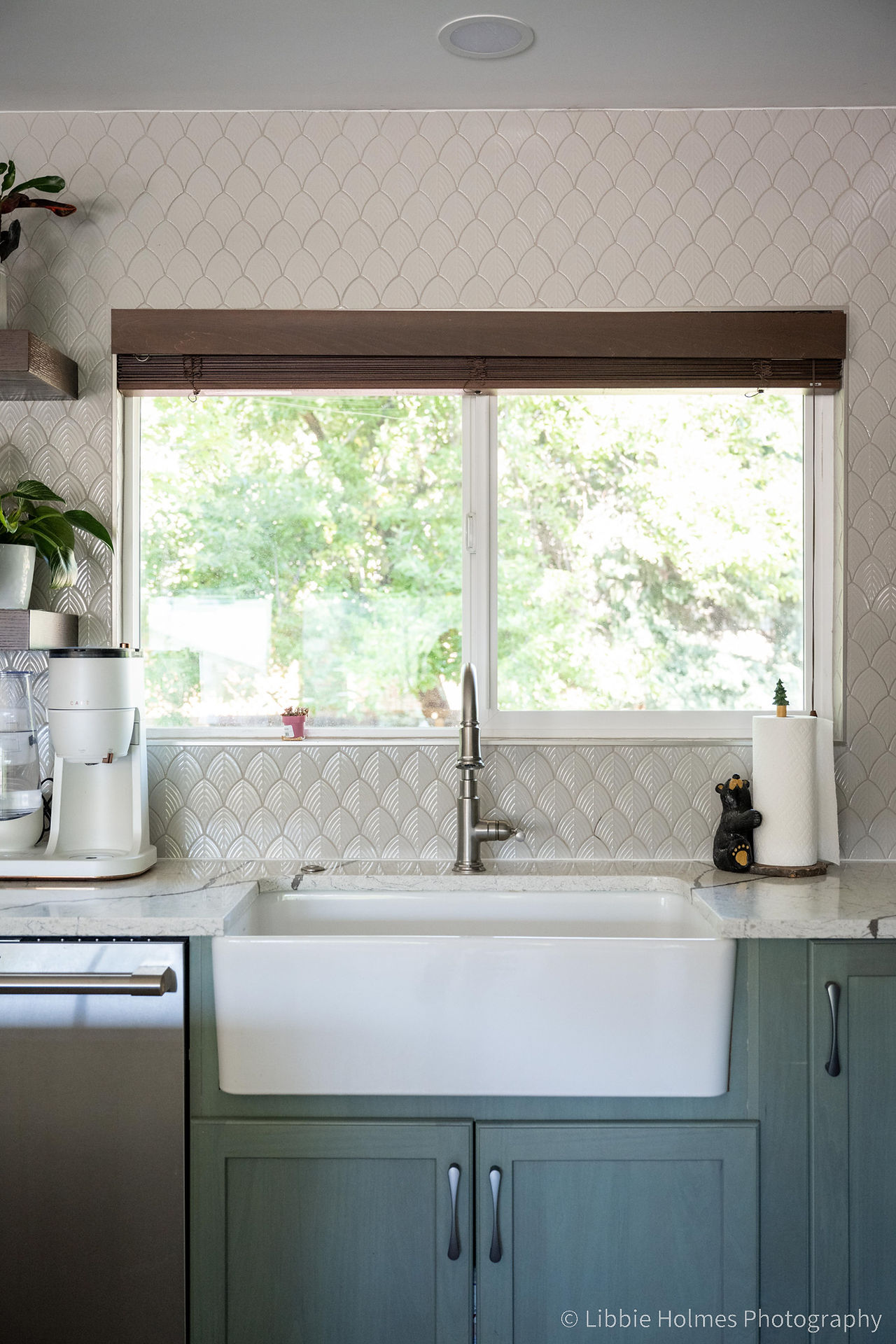 Newly remodeled kitchen with green cabinets,, wood floors and monogram appliances