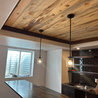 basement bar designed with ceiling panels made of beetle kill pine