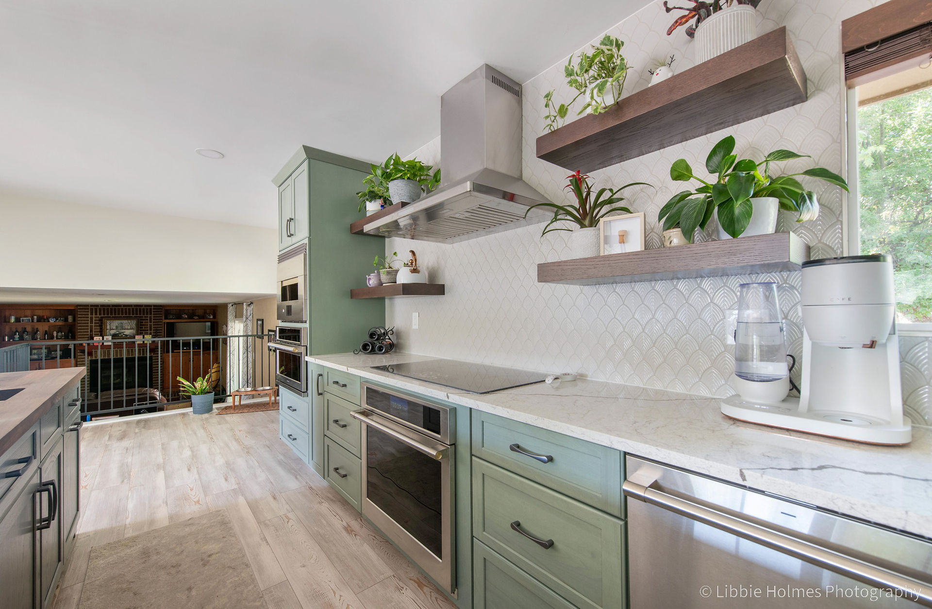 Newly remodeled kitchen with green cabinets,, wood floors and monogram appliances