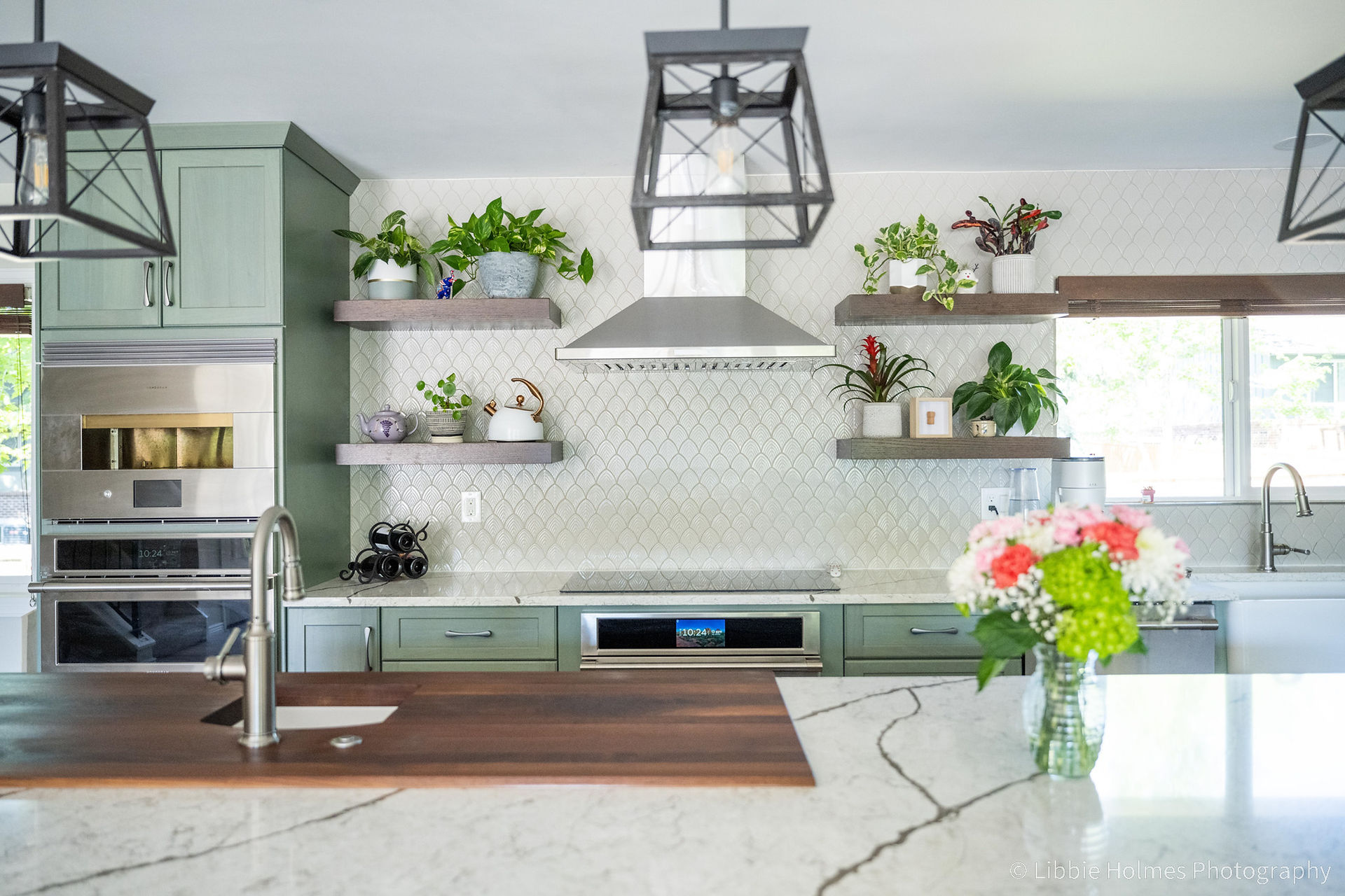 Newly remodeled kitchen with green cabinets,, wood floors and monogram appliances
