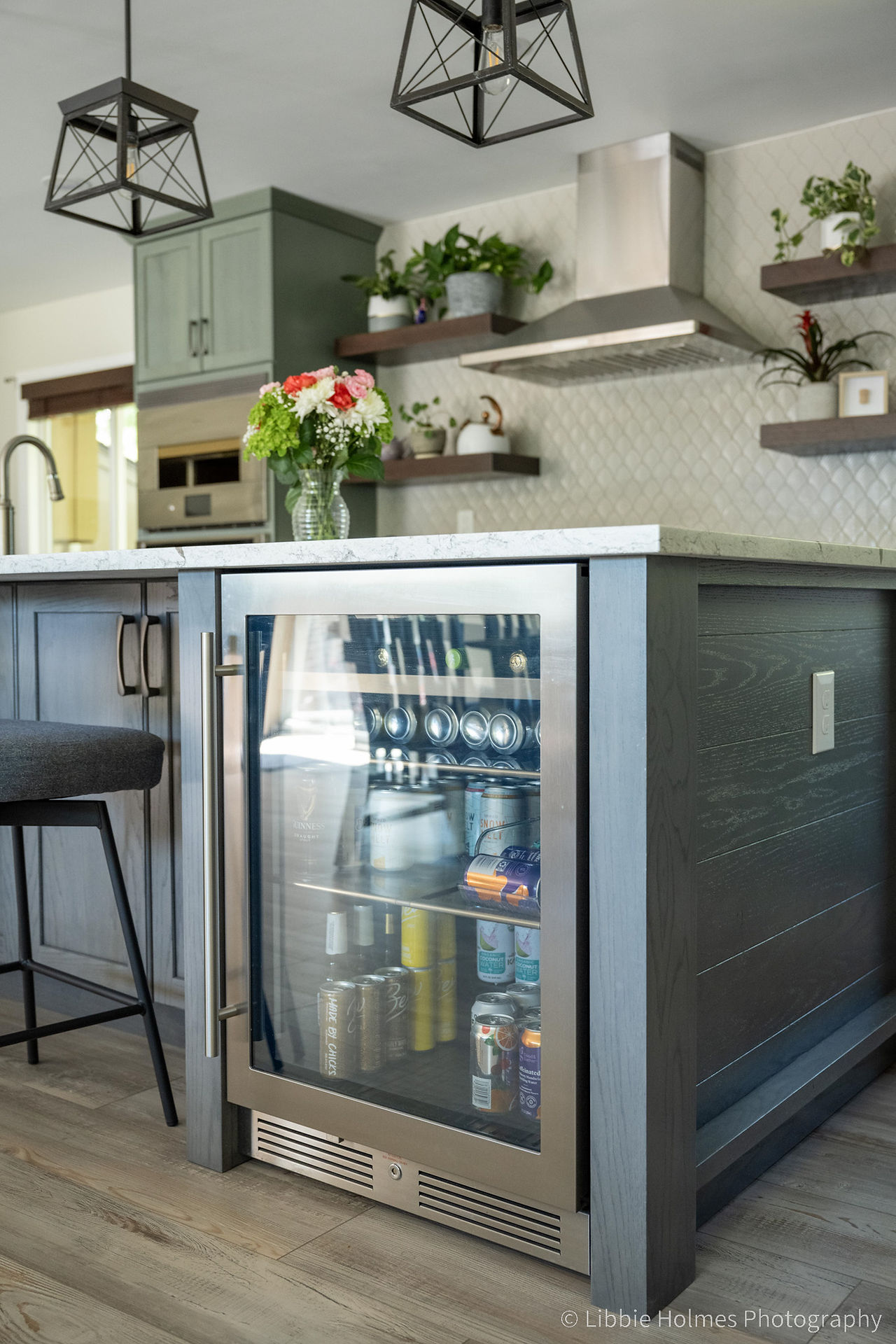 Newly remodeled kitchen with green cabinets,, wood floors and monogram appliances
