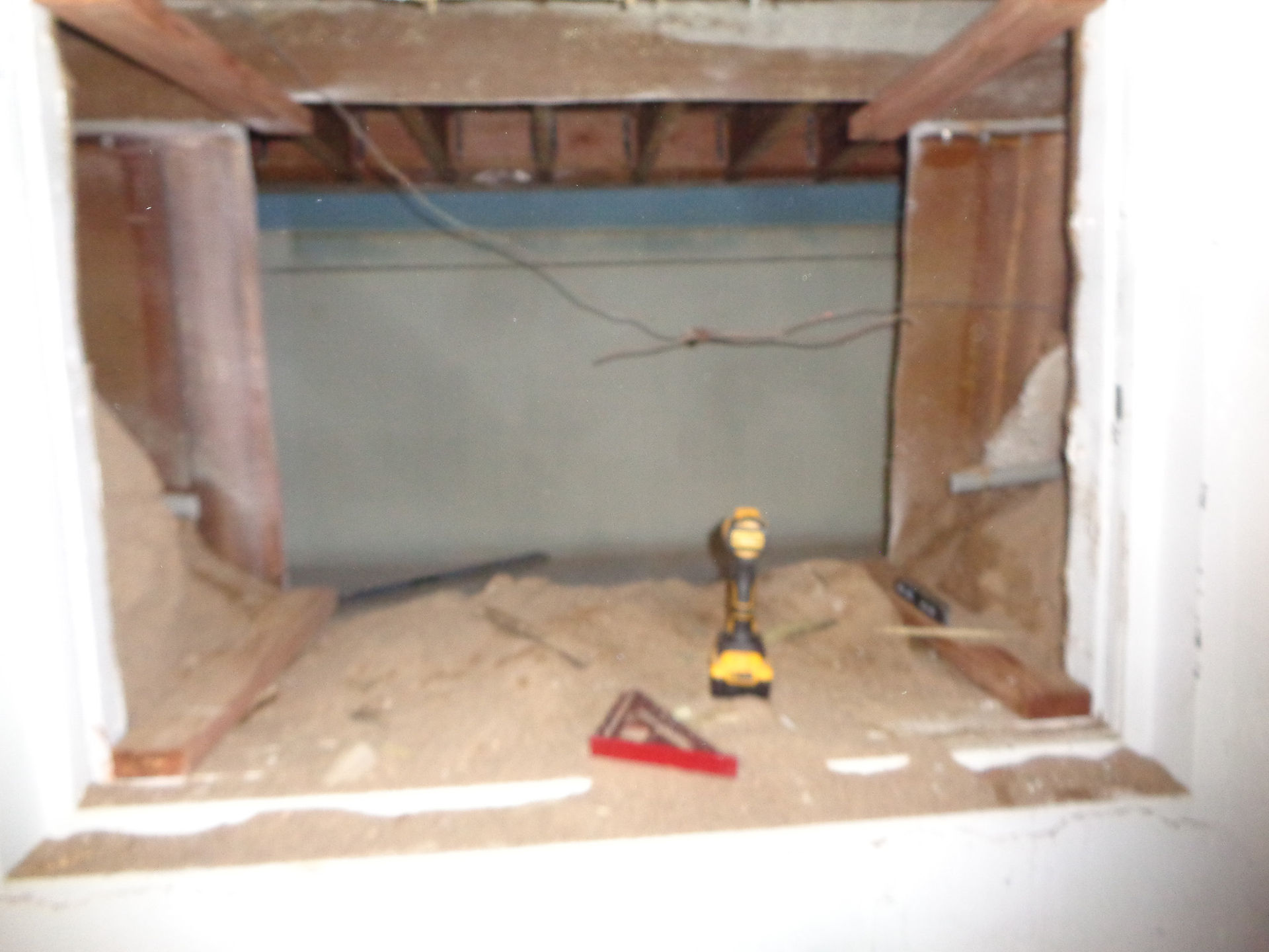 Wall cut open in garage to give access to the converted pool/crawl space