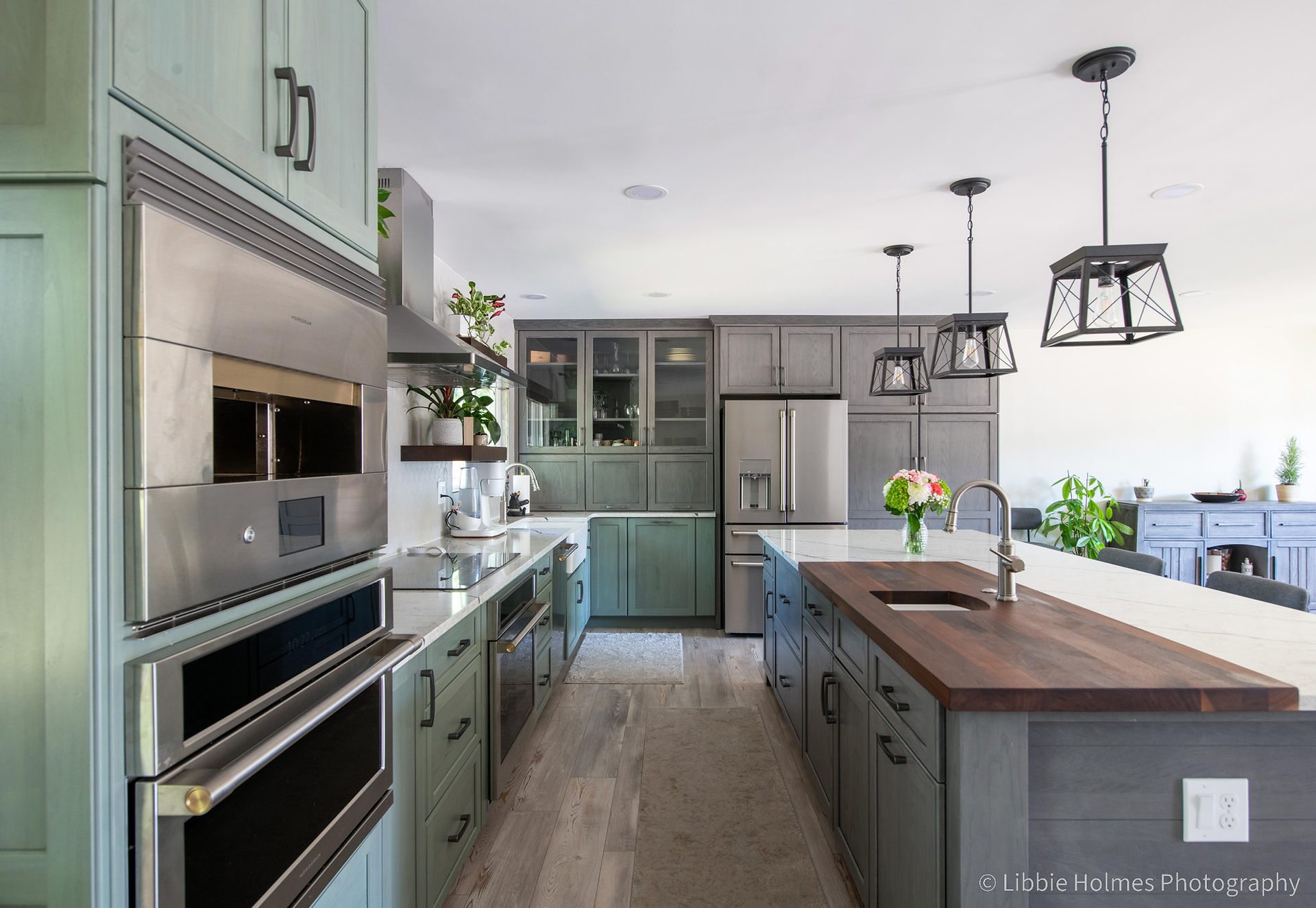 Newly remodeled kitchen with green cabinets,, wood floors and monogram appliances