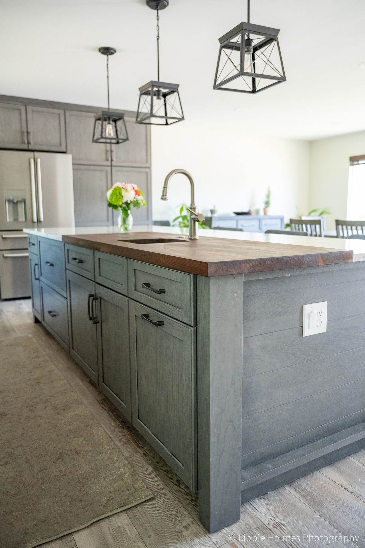 Newly remodeled kitchen with green cabinets,, wood floors and monogram appliances