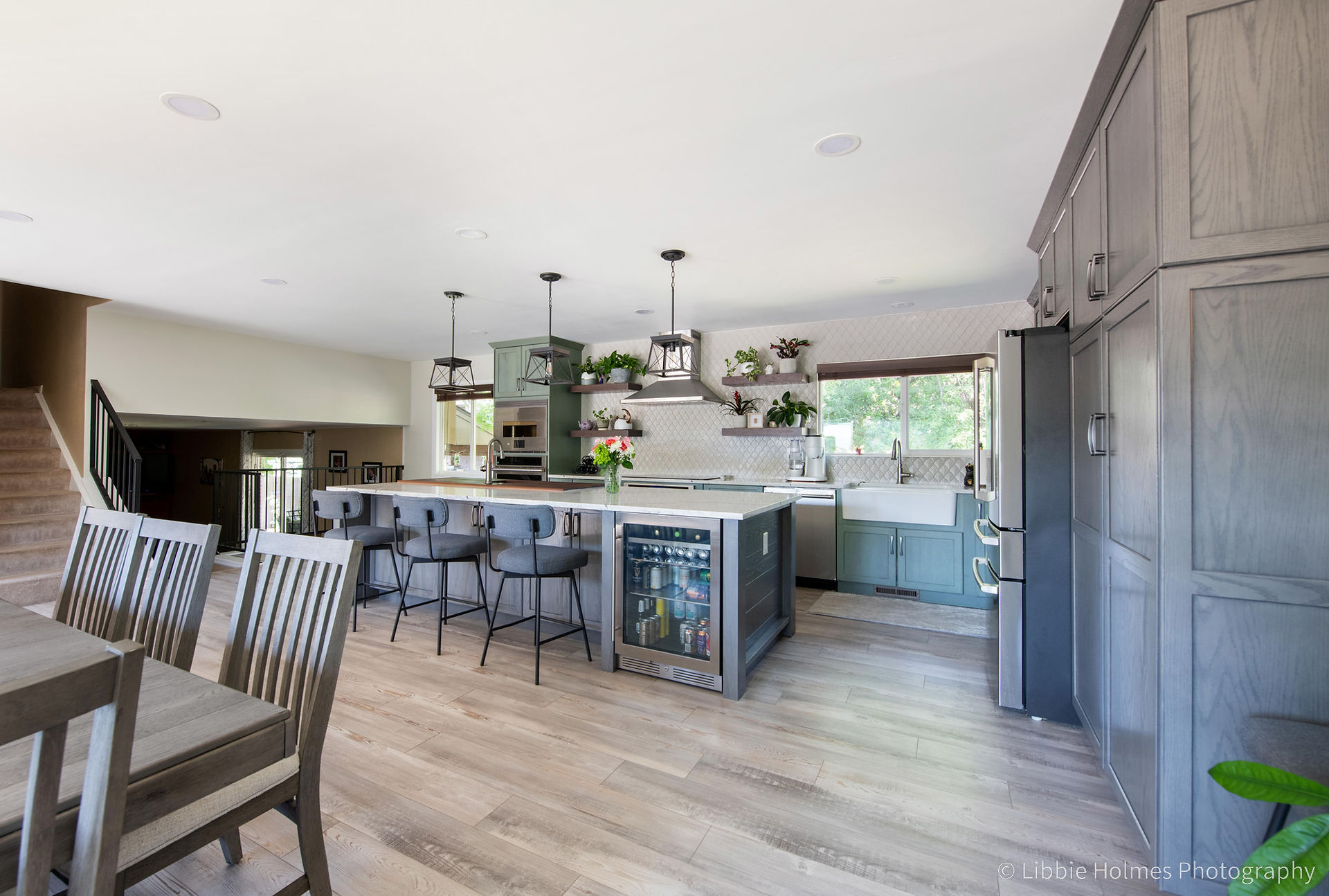 Newly remodeled kitchen with green cabinets,, wood floors and monogram appliances