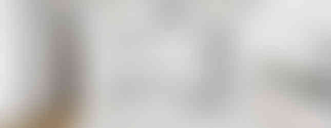 Modern white kitchen with pendant lights hanging above