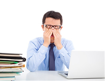 Photo of man suffering from dry eyes after prolonged computer use