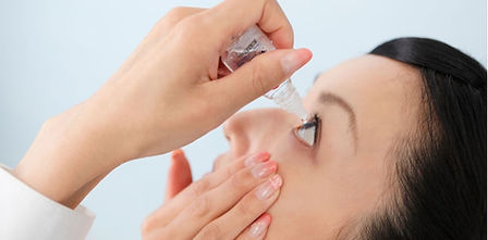Instilling atropine eye drops