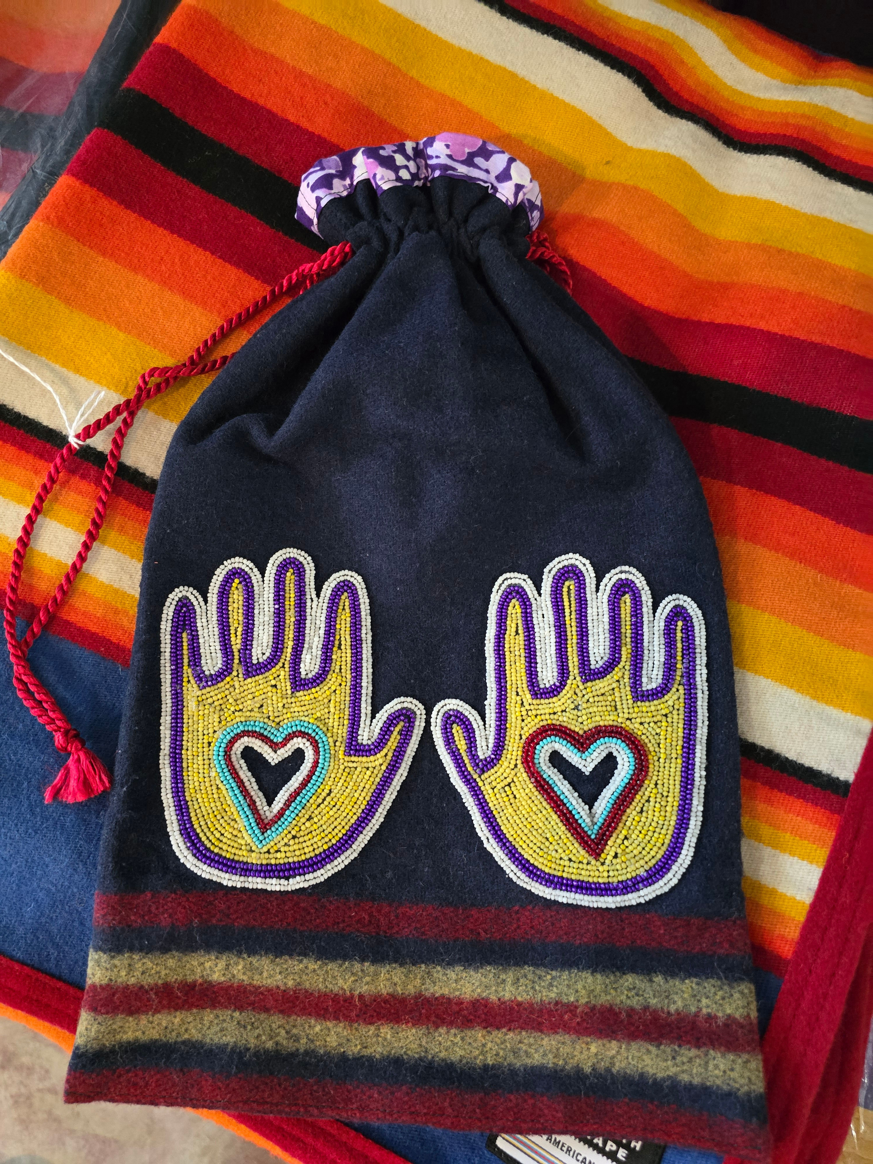 Broadcloth bag with beaded hands.
