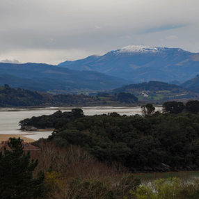 Uradaibai estuary in the Basque Country with a snowy hill in the background