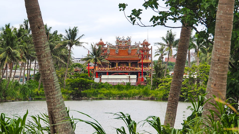 A temple seen through palm trees in Hualien.
