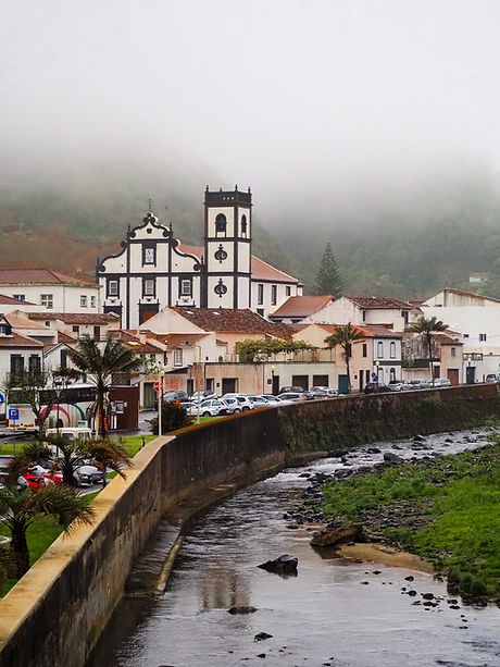 Povoacao's church, river, and misty hills in Sao Miguel Azores