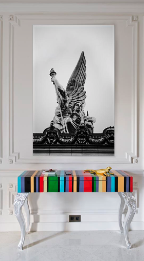Art hanging over multicolored table in renovated home