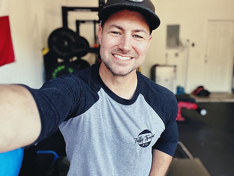 Bright and sunny picture of personal trainer Justin Tully in the Tully Trains garage gym