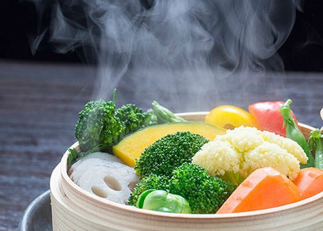 Legumes coloridos sobre vapor em close