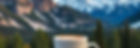 Three sisters mountains in the background (Canmore, Alberta) with a coffee mug, an latte a