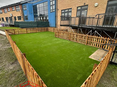Artificial turf lawn installed behind building
