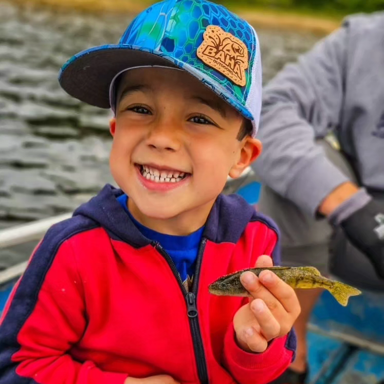 William holding a perch during a family trip in Michigan's Upper Peninsula