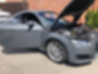 Grey car undergoing mobile ECU remapping with bonnet open
