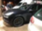 Technician performing mobile ECU remapping on a black SUV.
