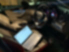 Laptop performing mobile ECU remapping inside a car