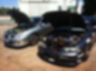 Two cars with open hoods for mobile ECU remapping.
