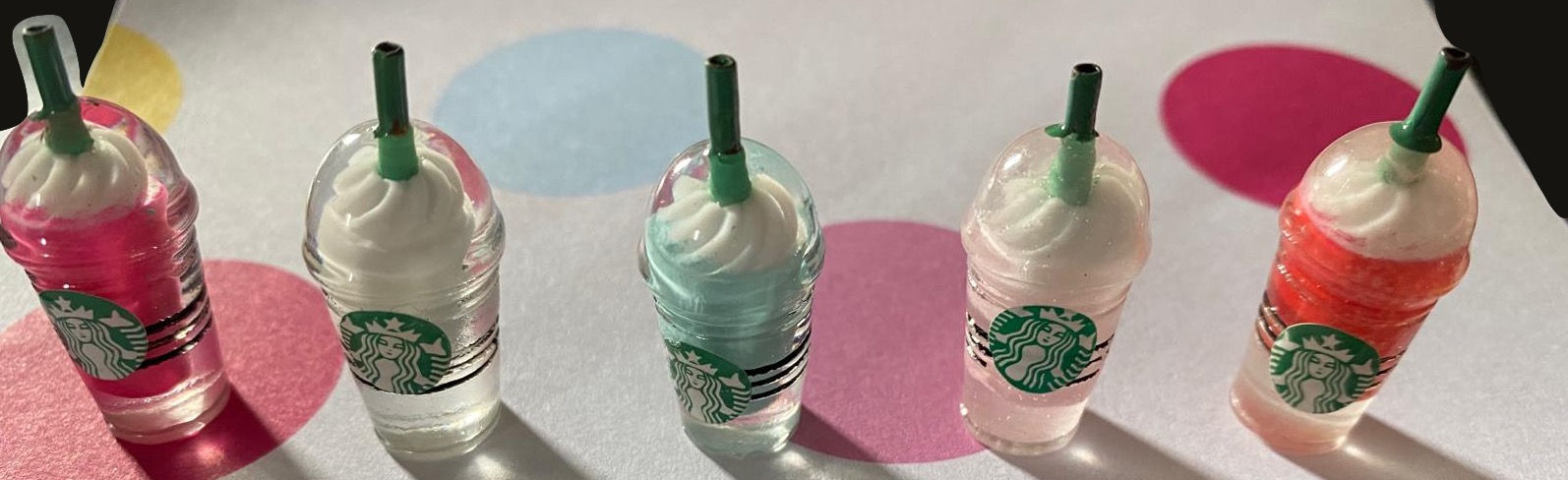 A SET OF FIVE MINIATURE STARBUCKS TOYS