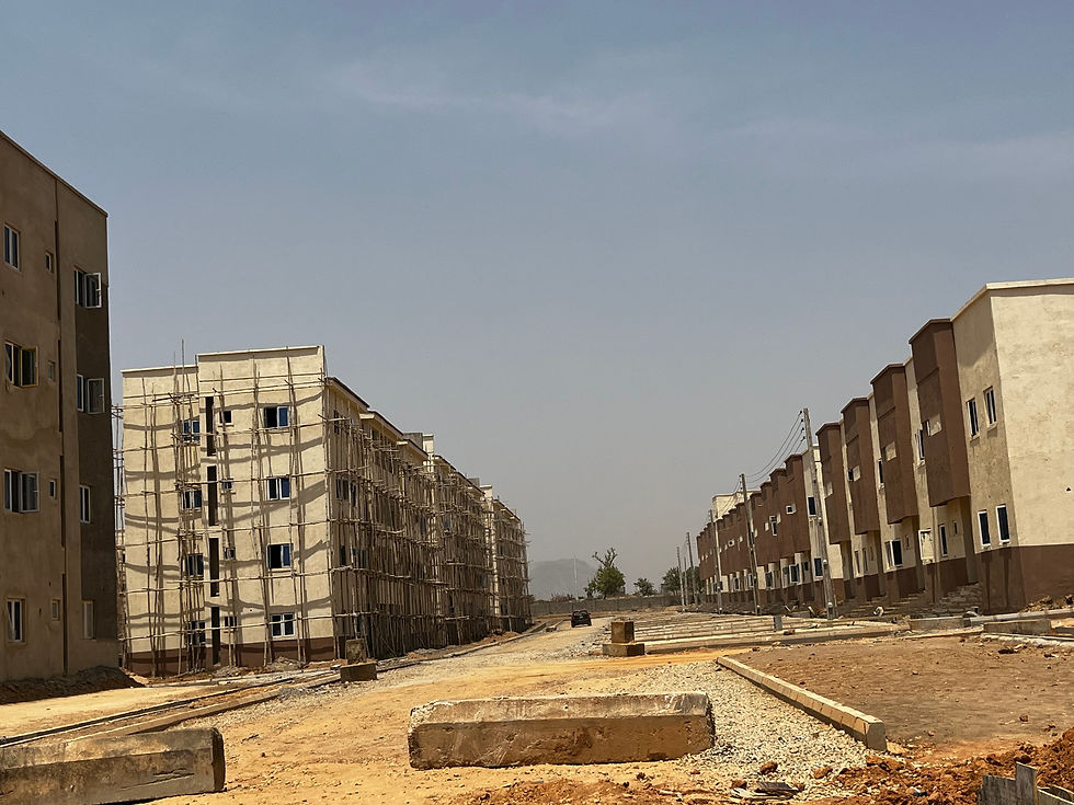 Multiple housing blocks appear at different stages of development within the estate.