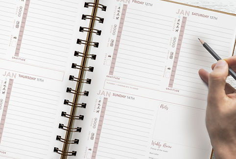 Mock up page of planner for marketing with handS.jpg