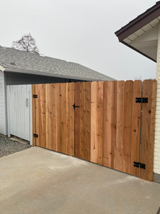 Custom wood double swing gate installation with cedar dog-ear pickets
