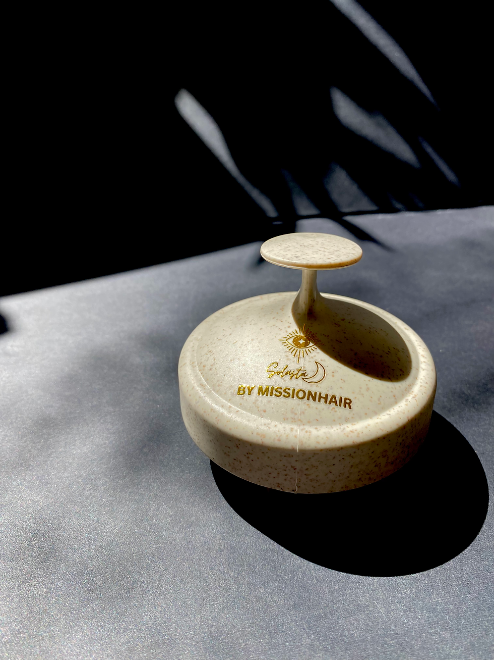 Eye-level view of a sleek bottle of premium hair serum on a marble countertop