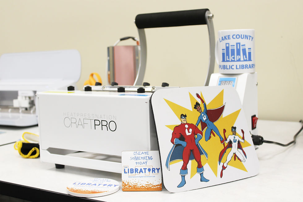 Craft Pro Heat Press with mug printed with library logo and mouse pad printed with super heroes