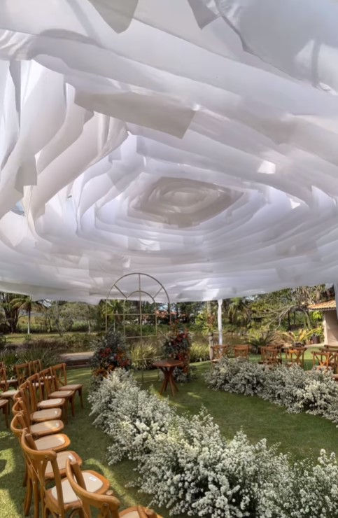 A tent with flowing ceiling drapes inspired by flower petals